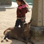 Baby girl with baby deer